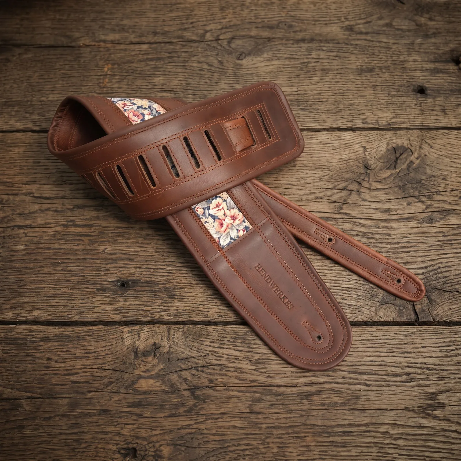 Floral jacquard leather guitar strap in a leather workshop