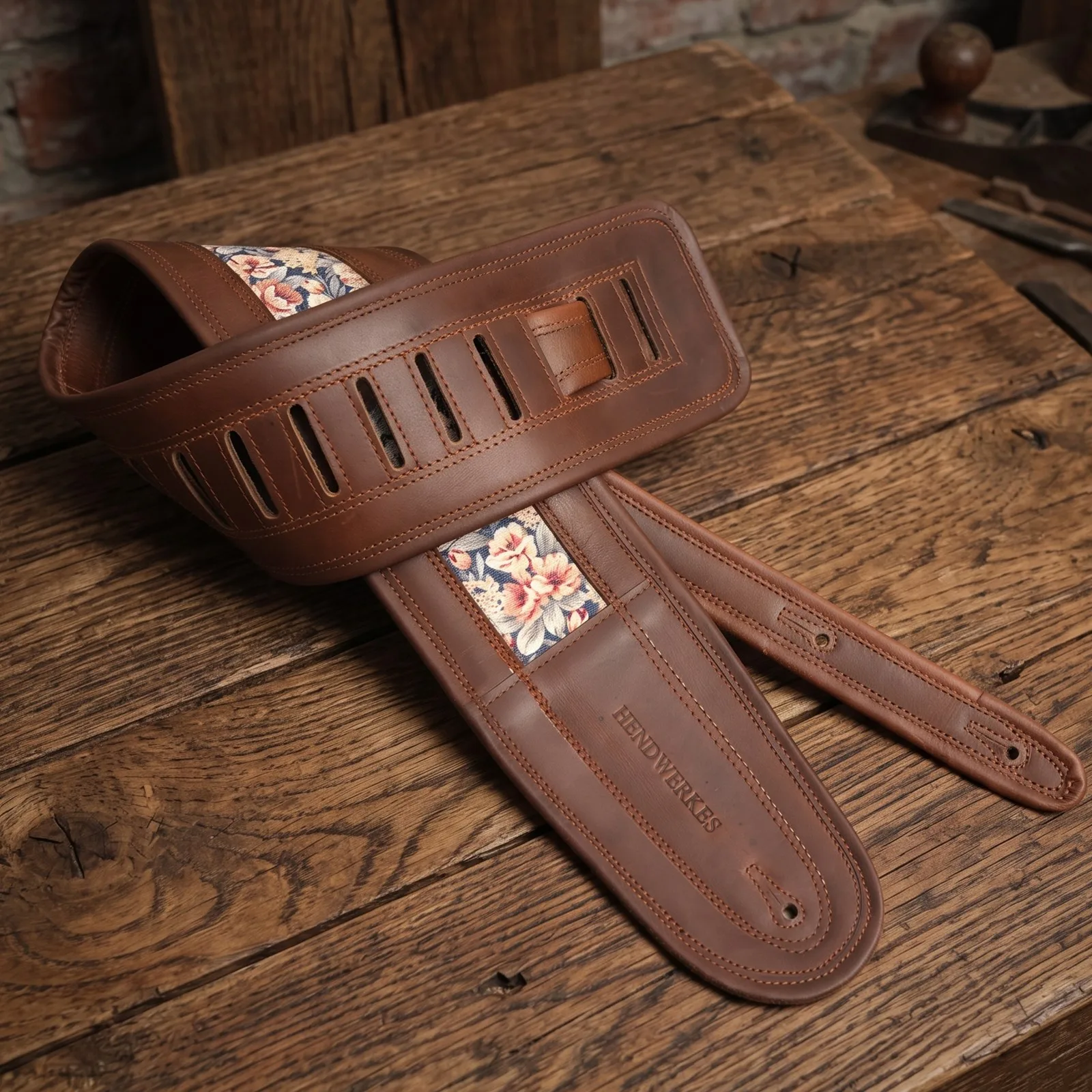 Floral jacquard strap coiled on a workbench
